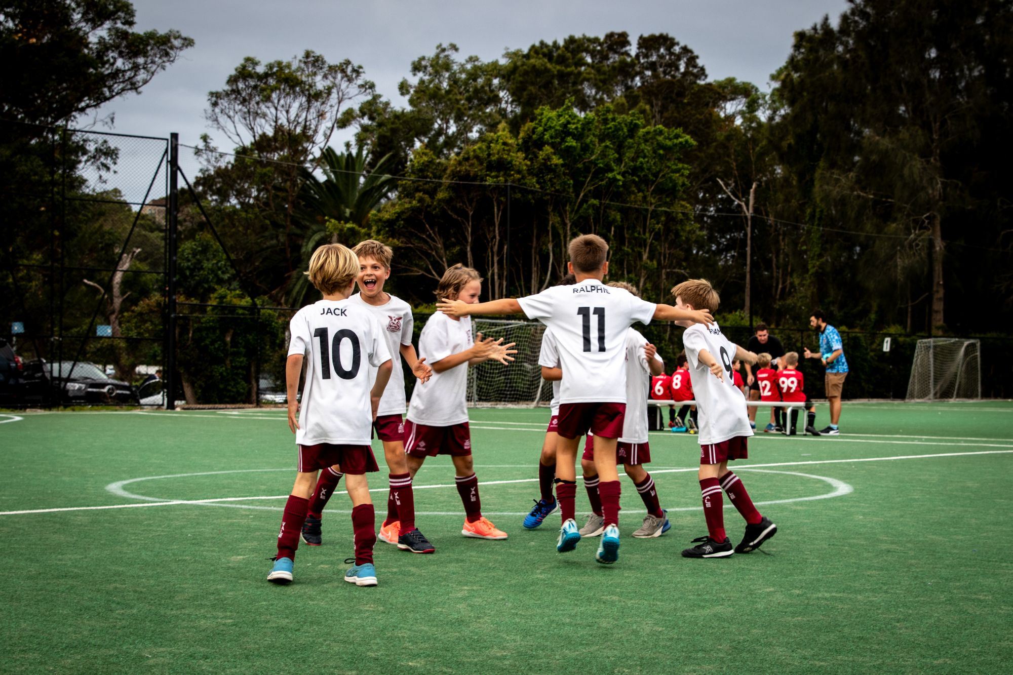Team celebrating together in a huddle after the match
